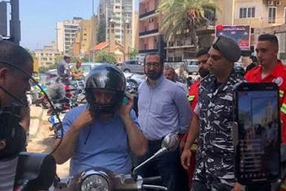 Security forces distribute helmets for road safety