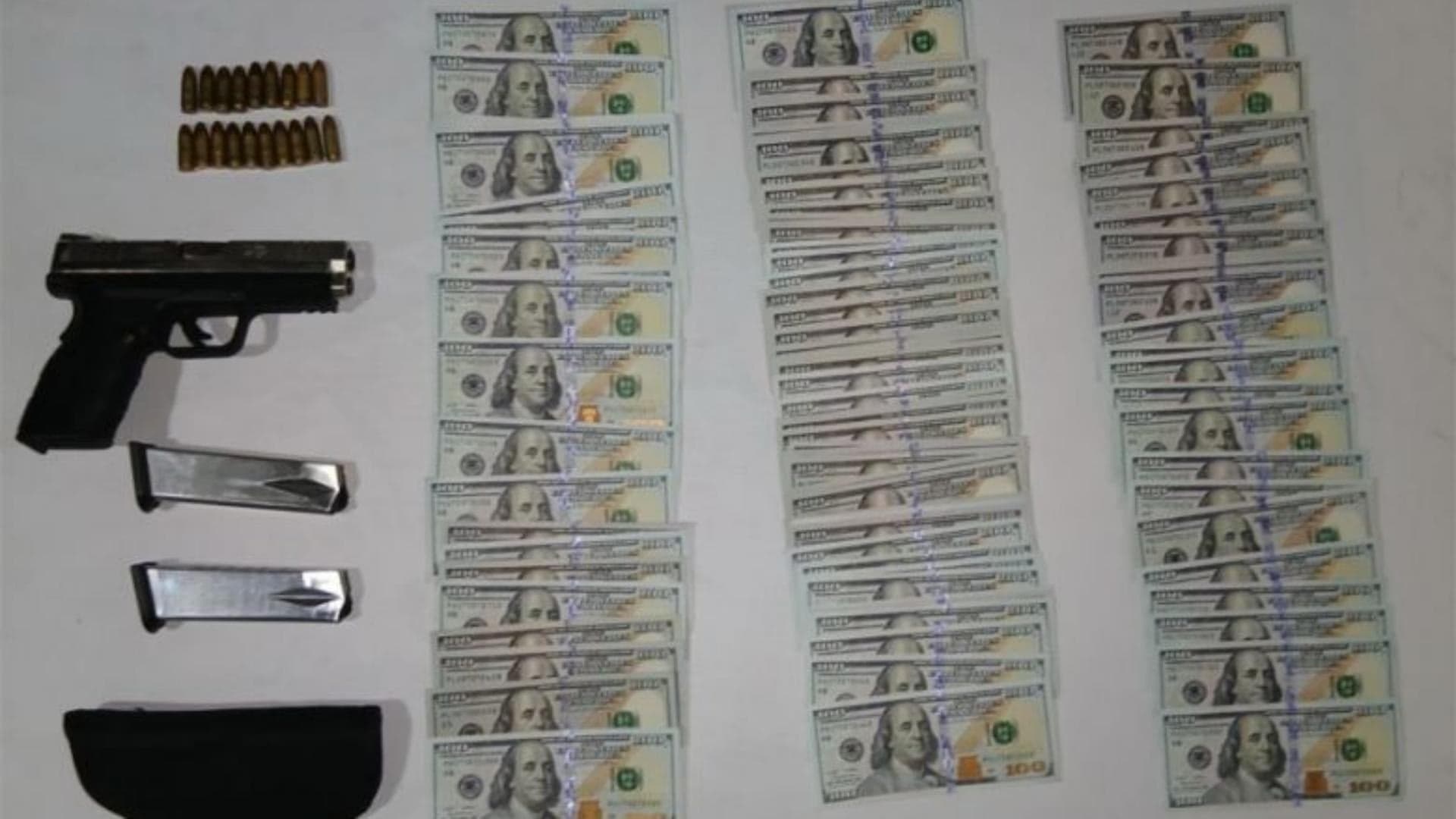 Images of fake cash weapons and drugs