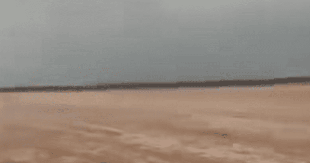 Floodwaters flow through Hamad Al-Ruwishd