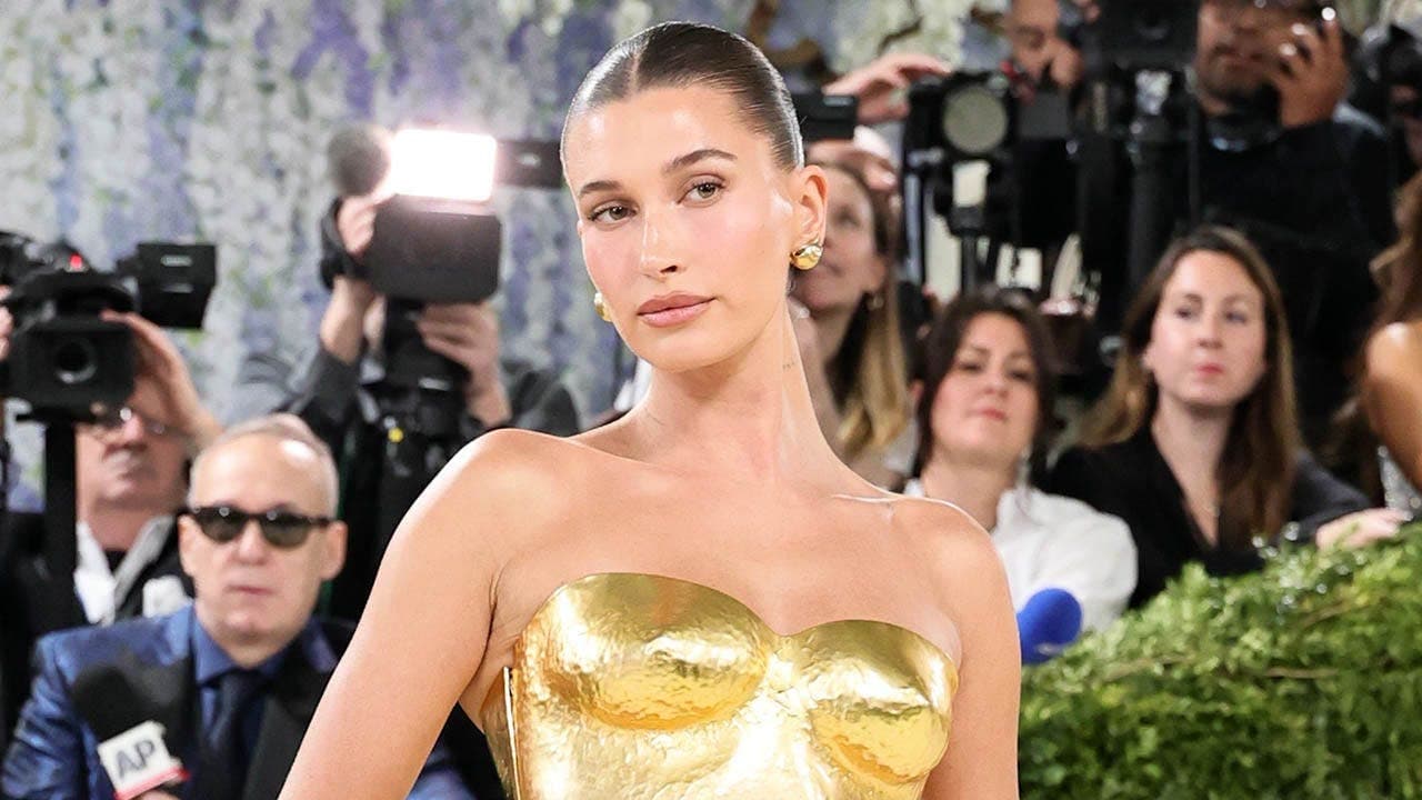 Hailey Bieber displays slim figure in yellow bikini