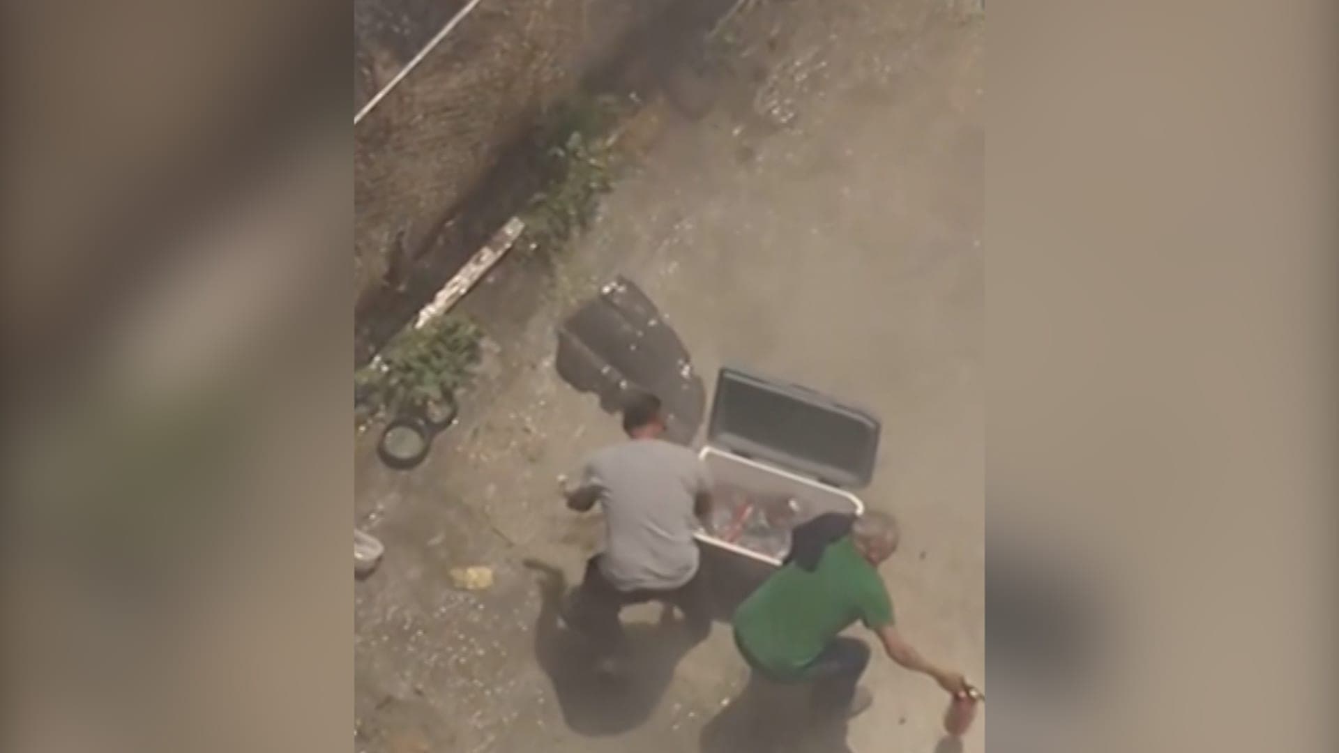 Car workshop workers combat fire with water bottles